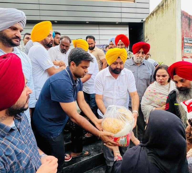 Punjab revenue, rehabilitation and disaster management minister hardeep singh mundian distributing essential dry ration among flood affected families in sasrali village of district ludhiana.
